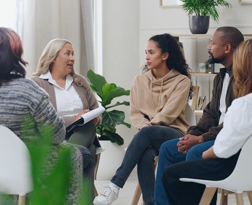 A young woman in conversation with a clinician during a depression-support counseling visit