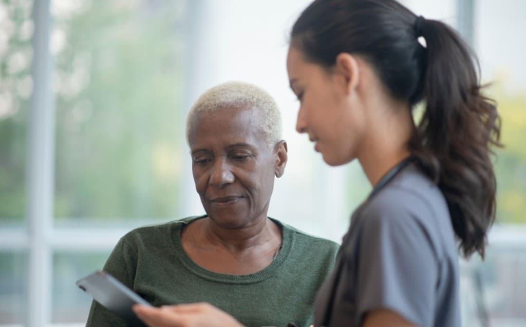 A facilitated support-group conversation representing Foundation-led mental health and wellness access pathways